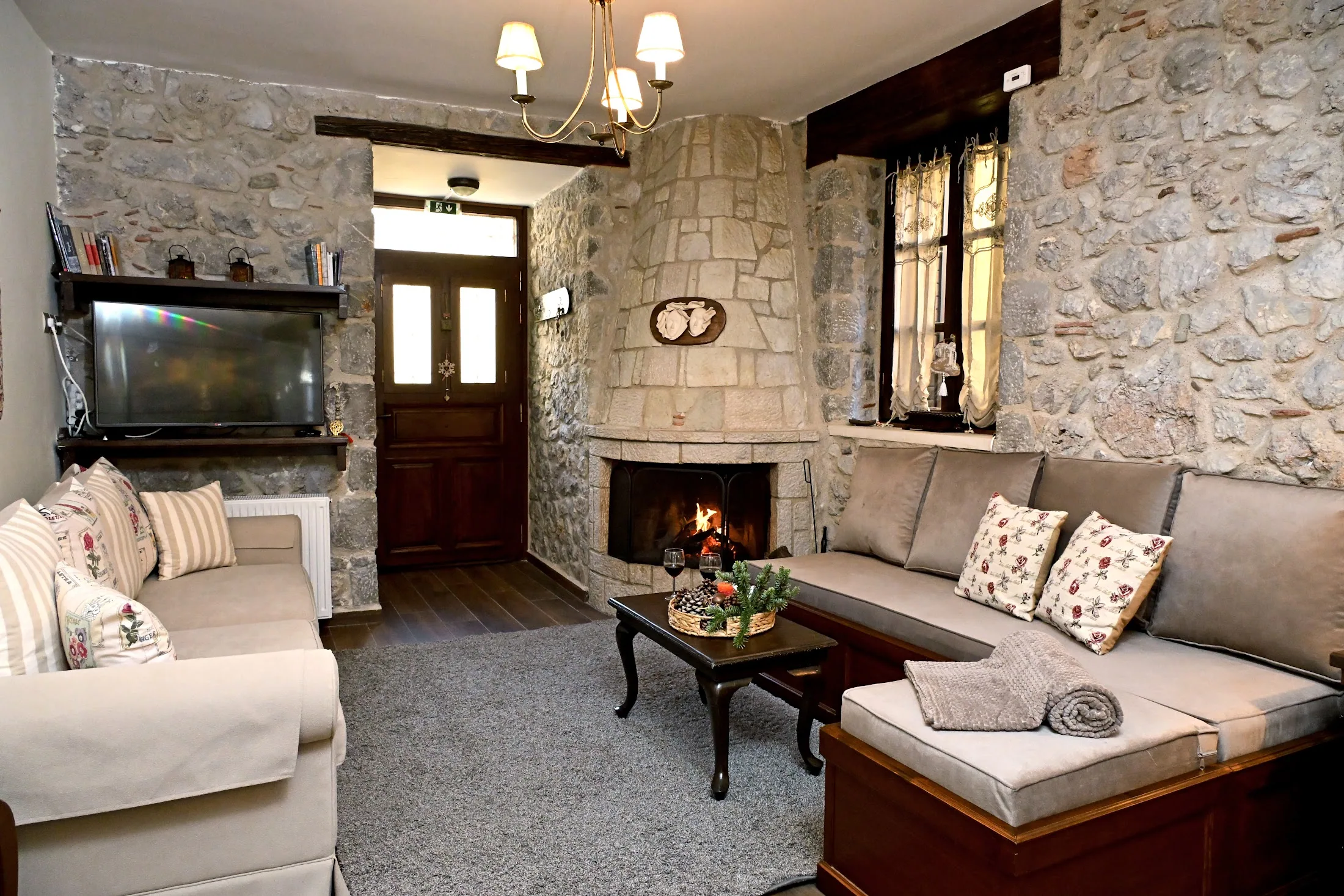 Warm Lithora living room with a lit stone fireplace